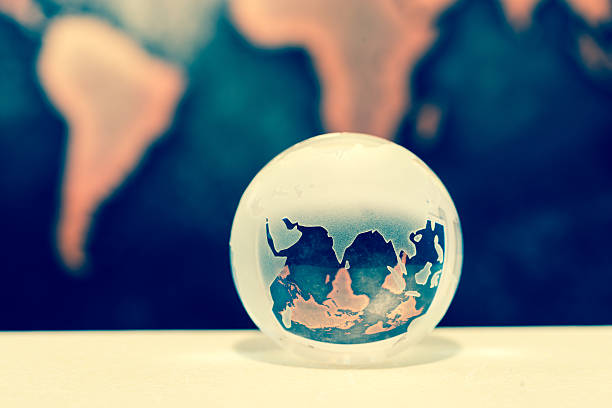 istock Crystal globe on books against grunge world map 610016056