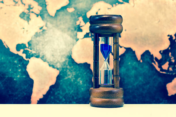 istock Hourglass against grunge world map 610016492