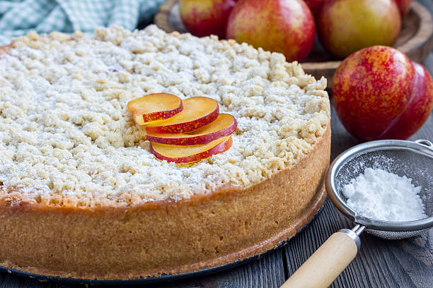 istock Homemade plum shortbread pie with streusel on wooden table 610017444