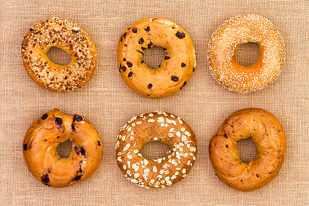 six different tasty fresh bagels on burlap - yiddish imagens e fotografias de stock