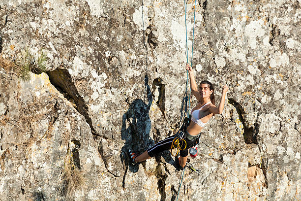 istock Woman climbing the mountain 610019584