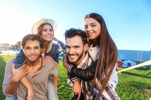 istock friends piggybacking in the park 610020246