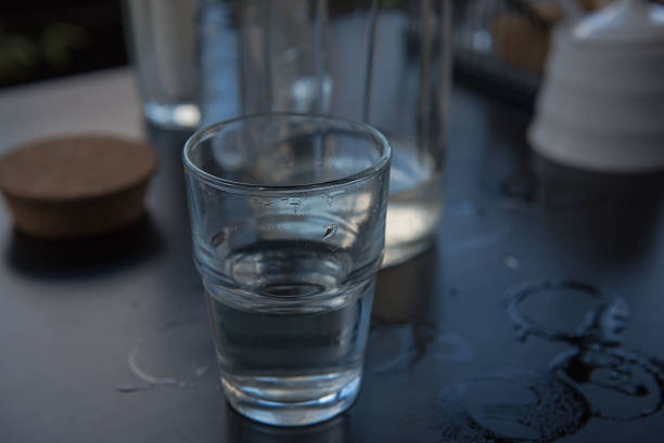 istock Cold water in a glass on a wooden black table. 610020334