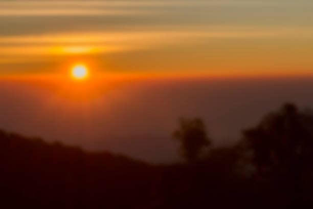 istock Blurred sunset behind the mountain with flare  background 610020866