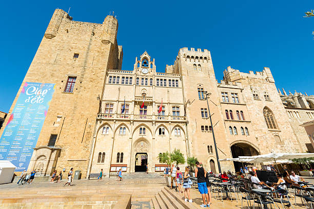 Narbonne city hall Narbonne, France - August 8, 2016: City hall in Narbonne. In front is a place with restaurants and many tourists are around. narbonne stock pictures, royalty-free photos & images