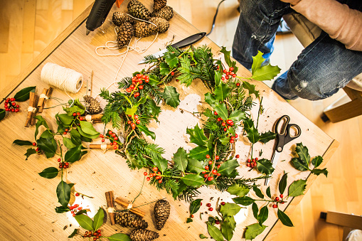 Family preparing advent wreath for christmas