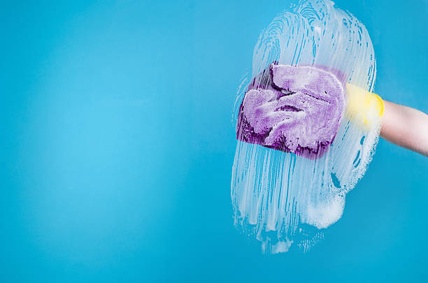 istock Hand cleaning a window or glass 610032850