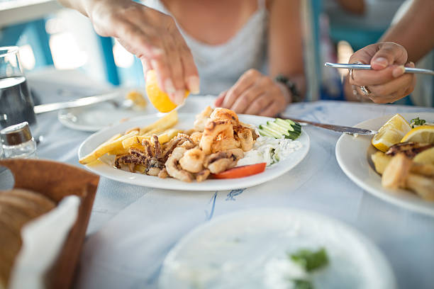 women in restaurant have seafood for lunch stock photo