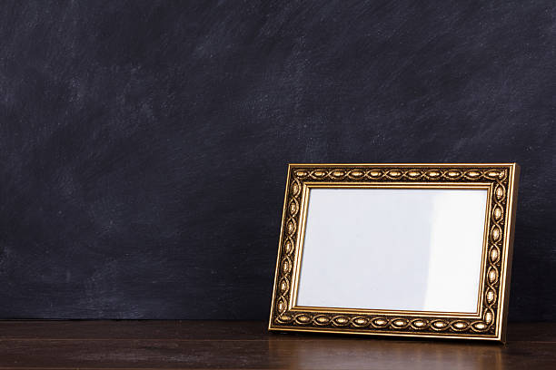 Picture frame against a dirty blackboard background stock photo