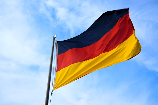 German national flag (black, red, gold) waving in the wind