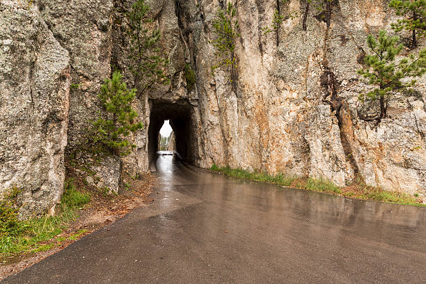 Needles Eye Tunnel A road passing through a single lane tunnel on a rainy day. needles eye stock pictures, royalty-free photos & images