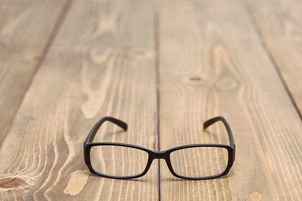 istock Black glasses on wood table 610039878
