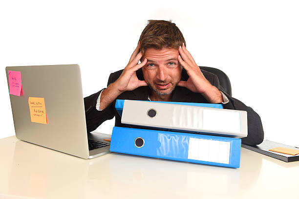 istock tired wasted businessman working in stress at office computer exhausted 610039930