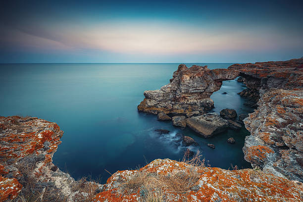 арки скала возле tyulenovo. длинные выдержки выстрел - moody sky outdoors digital composite sunset стоковые фото и изображения