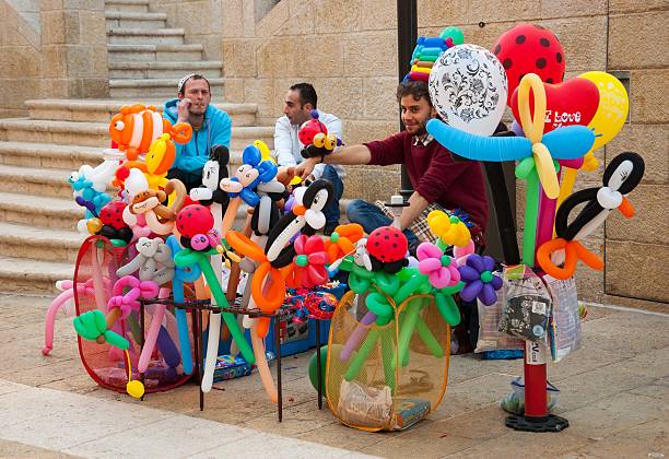 Jerusalem, Israel - February 19, 2014: Balloon twisters specializing in entertaining events promoting themselves at Mamilla pedestrian promenade.