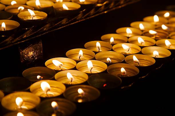 istock Candles in a dark church 610040974