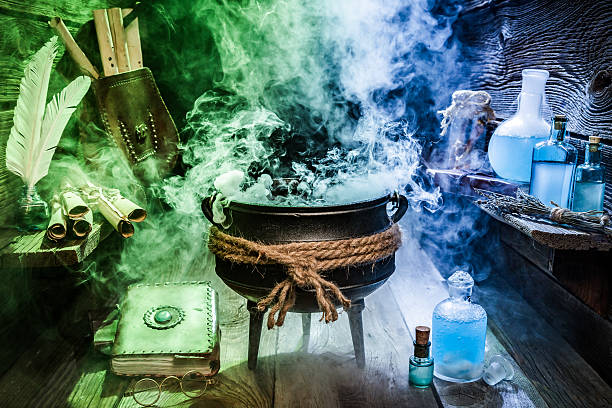 istock Old witcher cauldron with blue and green smoke for Halloween 610042332