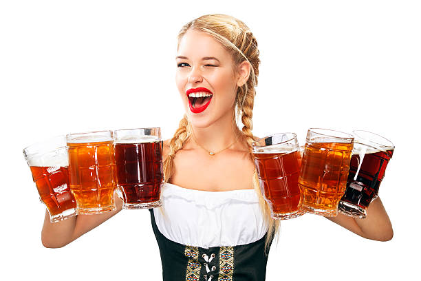 Young sexy Beer Fest waitress, wearing a traditional Bavarian dress, serving stock photo