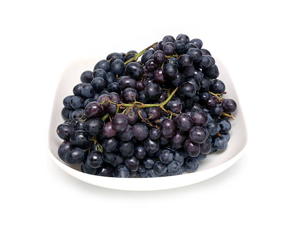 istock Ripe grape bunches in white bowl isolated 610043452