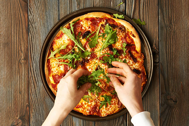 istock Home made pizza on wooden table 610043766