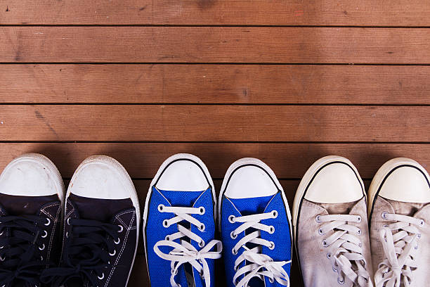 istock Old canvas shoes on a wooden floor 610043808