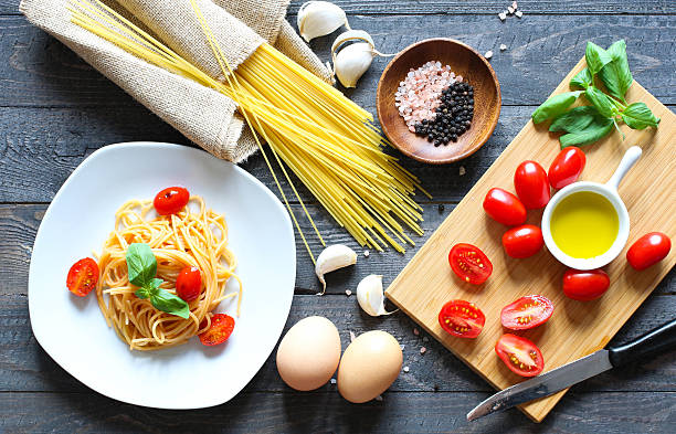istock Top view of italian ingredients for tomato and basilic spaghetti 610045516