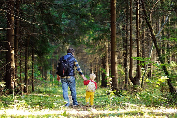 istock Father and son walking during the hiking activities in forest 610046626