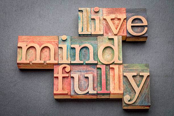 live mindfully in wood type live mindfully - word abstract in letterpress wood type against gray slate stone printing block photos stock pictures, royalty-free photos & images