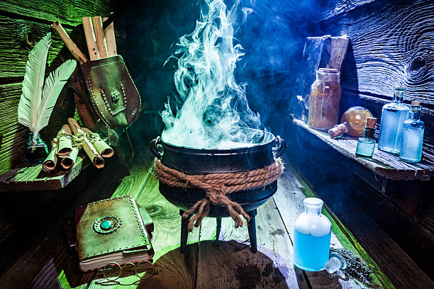 istock Vintage witch pot with magic mixture, blue potions and books 610047944