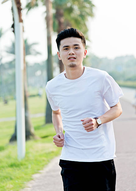 istock Young man jogging outdoors 610050234