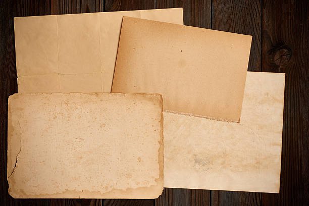 istock Vintage paper on textured old wooden background 610050334