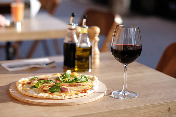 istock Pizza and red wine in restaurant 610050540