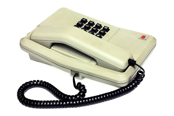 istock Old simple office desk phone and cable 610050774