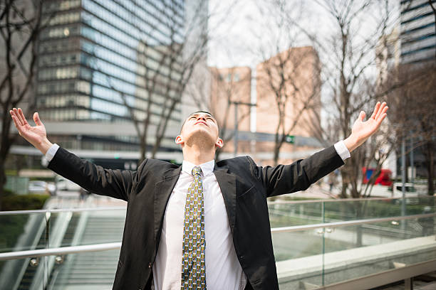 istock praying business man in tokyo 610050852