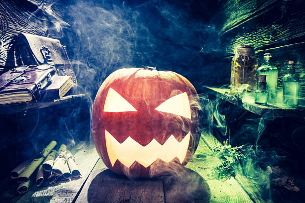 istock Smoking Halloween pumpkin with blue and green smoke 610051740