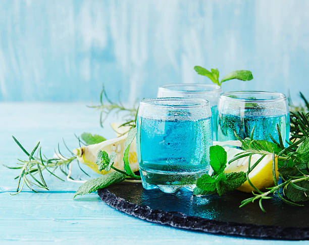 istock Blue curacao liqueur or sambuca with lemon 610114538
