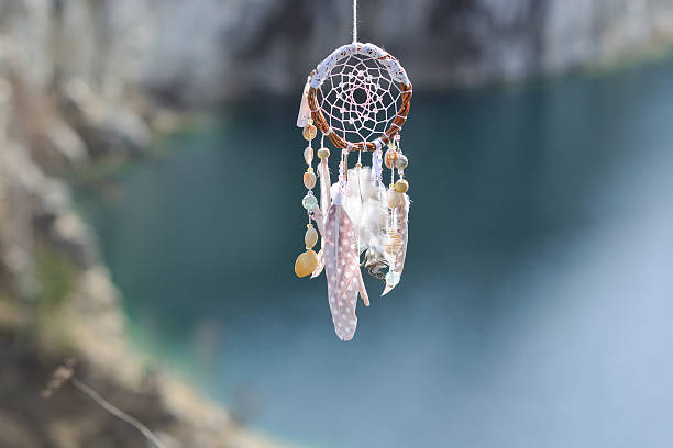 istock Handmade native american dream catcher on background of lake 610114864