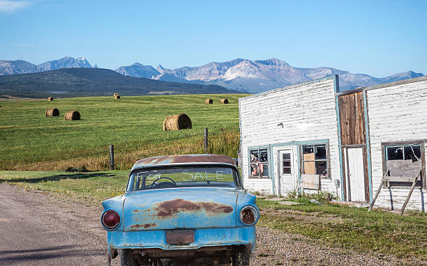 horizontal image of an old blue car with a 