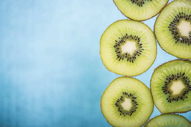 Sliced vibrant green kiwi border background