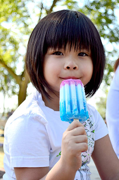 istock Little Chinese Girl eating popsicle 610115854