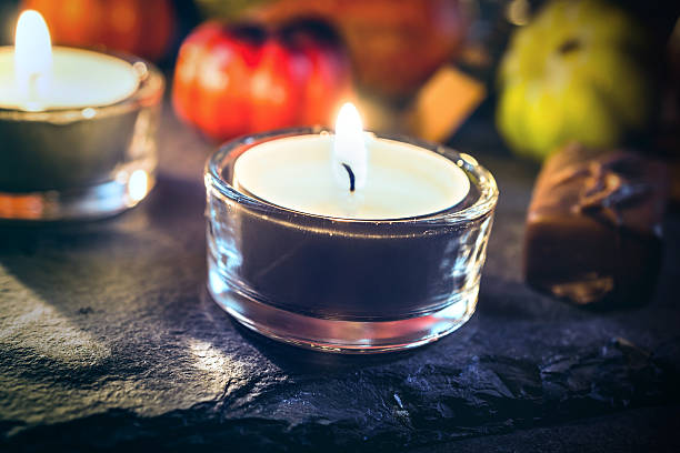 istock Halloween Decoration With Two Candlelights, Chocolate And Pumpkins On Slate 610116366