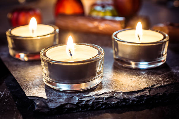 istock Halloween Decoration With Three Tealights, Chocolate And Pumpkin 610116524