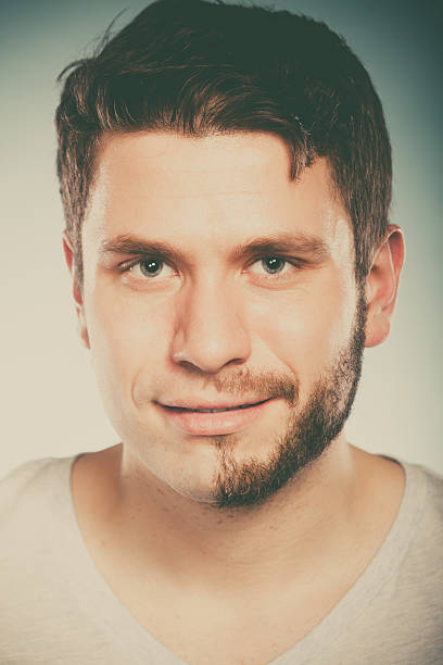 istock Young man with half shaved face beard hair. 610116980