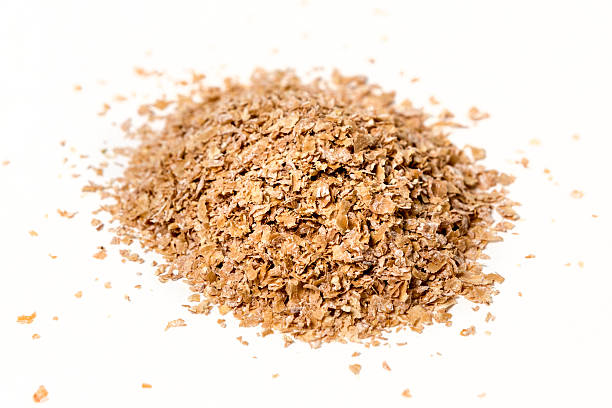 istock Pile of wheat bran isolated on white background 610117192