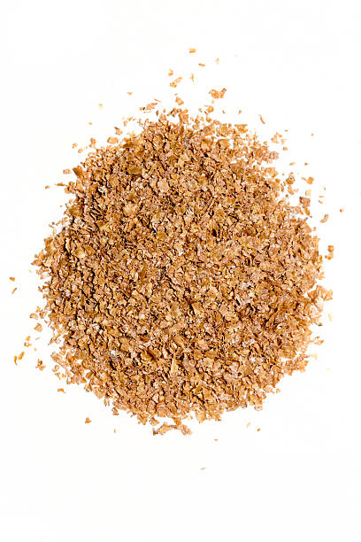 istock Pile of wheat bran isolated on white background 610117216