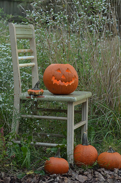 istock Halloween Jackolantern decoration old chair outdoors 610118156
