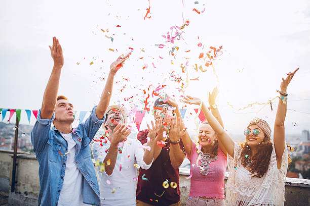 istock Joyful friends with confetti at the rooftop party 610118372