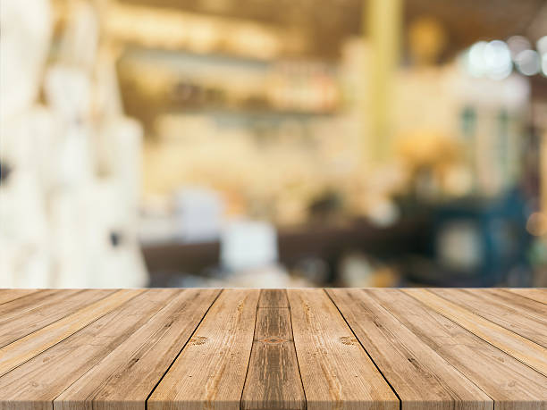 istock Wooden board empty table blur in coffee shop. 610119682