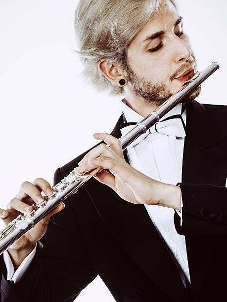 istock Male flutist wearing tailcoat plays flute 610120512