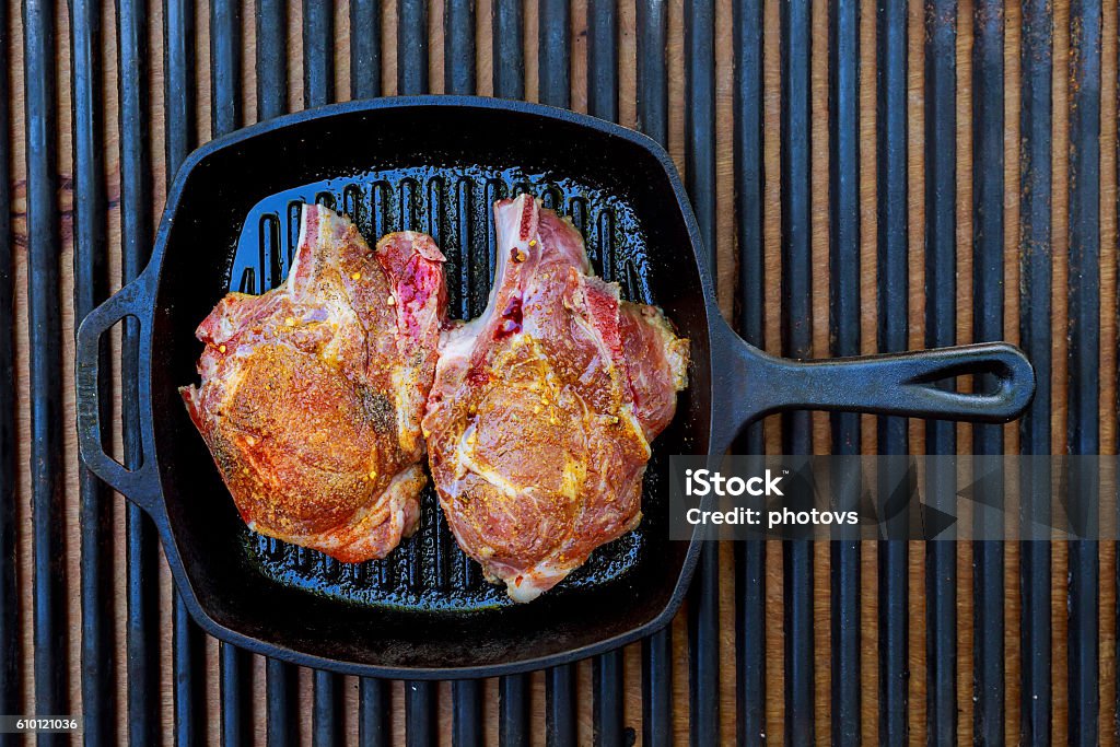 raw uncooked fat lamb pork fresh meat : raw uncooked fat lamb pork rib and fillet with green stuff and red chili pepper on wooden plate isolated over white background Beef Stock Photo